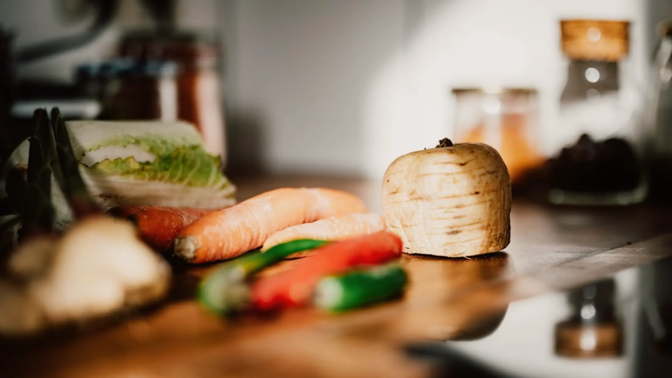 Fresh vegetables on a wooden counter in warm light